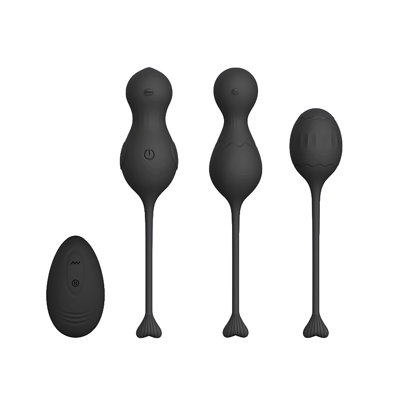 Set of black silicone kegels or massage tools with a black remote control on a transparent background
